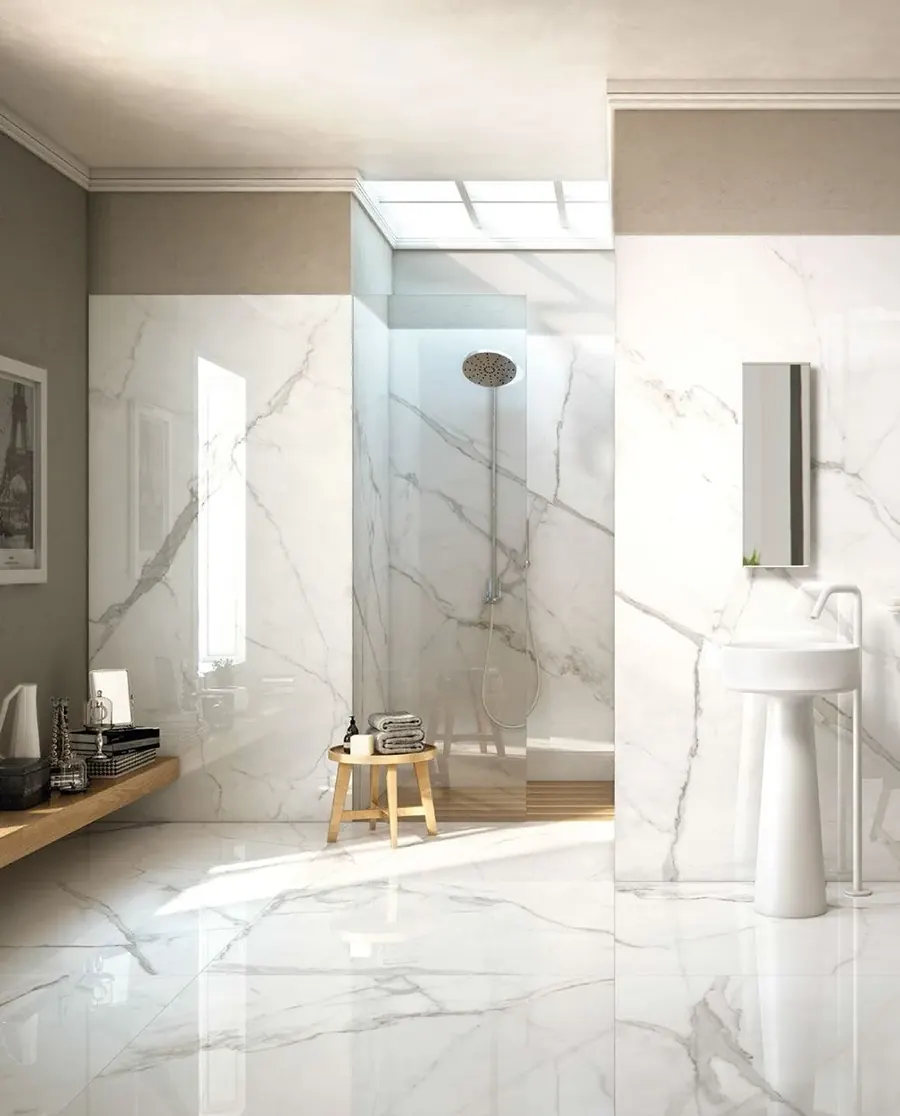 Marble-look tile bathroom with a walk-in shower and skylight