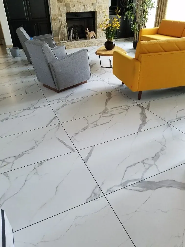 Large-format marble-look porcelain floor in a bright living room